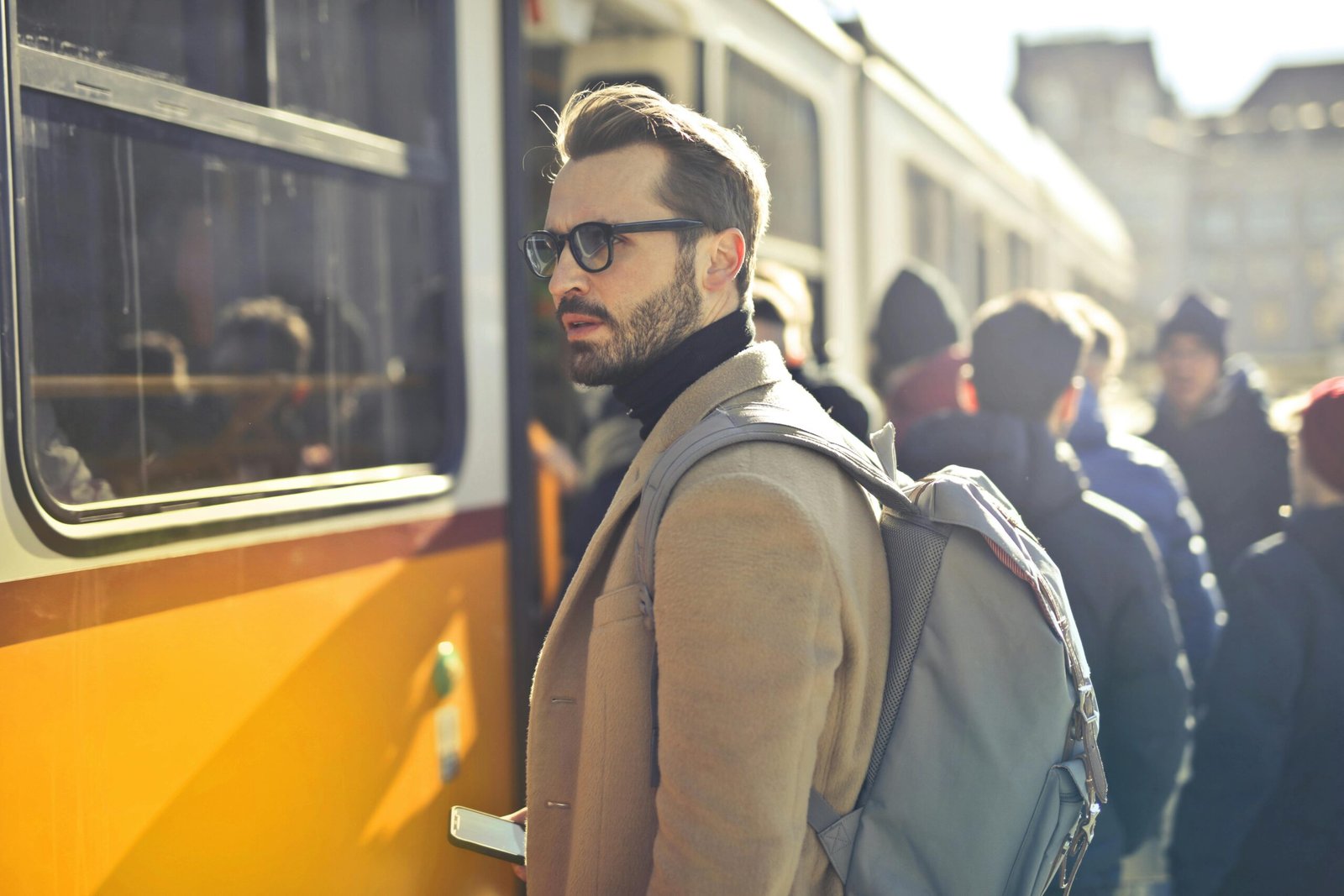 pexels-photo-837358-837358 A stylish man with a backpack boards a tram in bustling Budapest, Hungary, during the day.